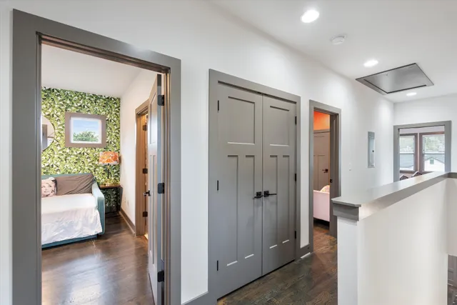 a view of a bedroom with a bed and a hallway