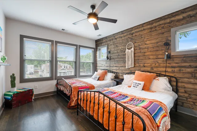 a bedroom with two beds and a chandelier