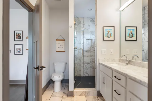 a spacious bathroom with a granite countertop sink toilet and shower