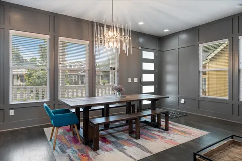 a workspace with hardwood table and windows