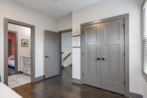 a view of a hallway with wooden floor