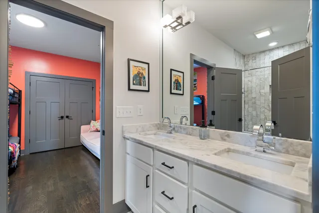 a spacious bathroom with a granite countertop sink and a mirror