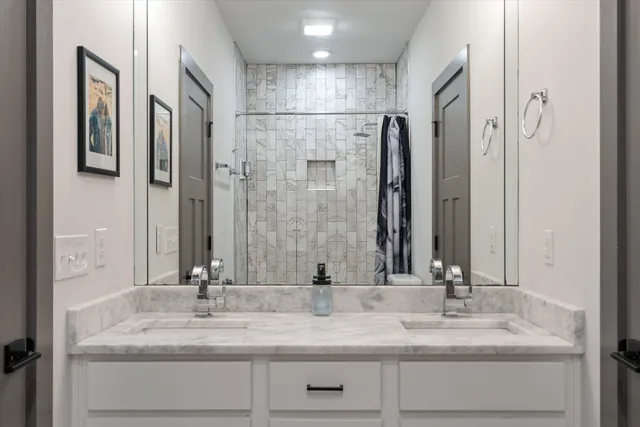 a bathroom with a double vanity sink and a mirror