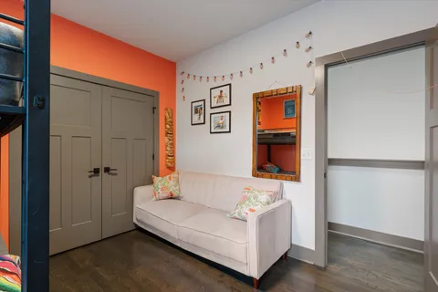 a hallway with couch and wooden floor