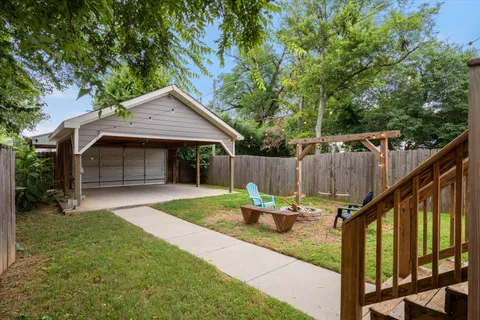 a backyard of a house with table and chairs