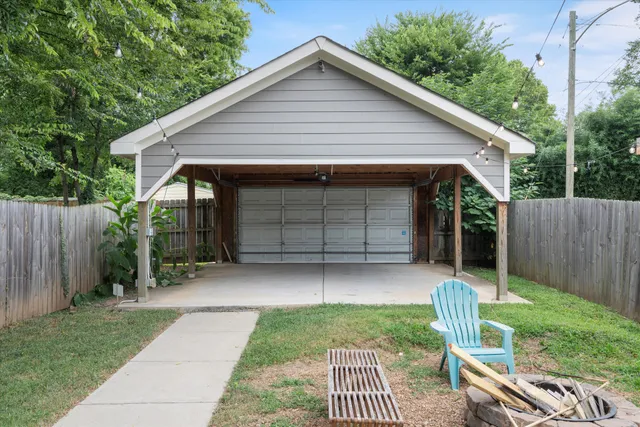 a view of a house with a yard and outdoor seating
