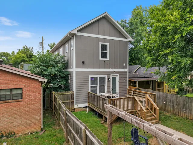 a view of house with a yard and furniture