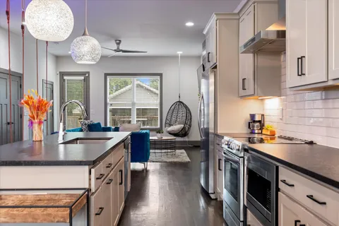 a kitchen with stainless steel appliances granite countertop a stove and a sink