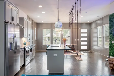 a kitchen with counter top space a sink appliances and cabinets