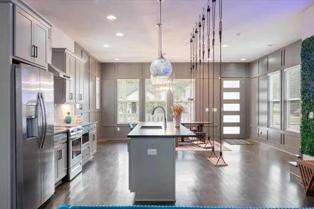 a kitchen with counter top space a sink appliances and cabinets