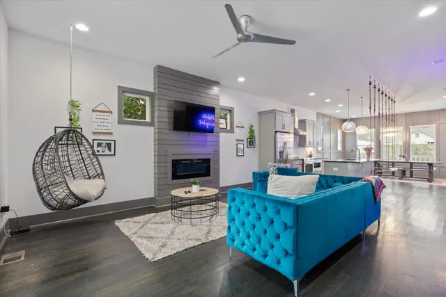 a living room with fireplace furniture and a wooden floor