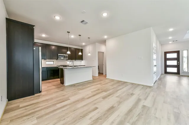 a kitchen with stainless steel appliances granite countertop a stove and a refrigerator