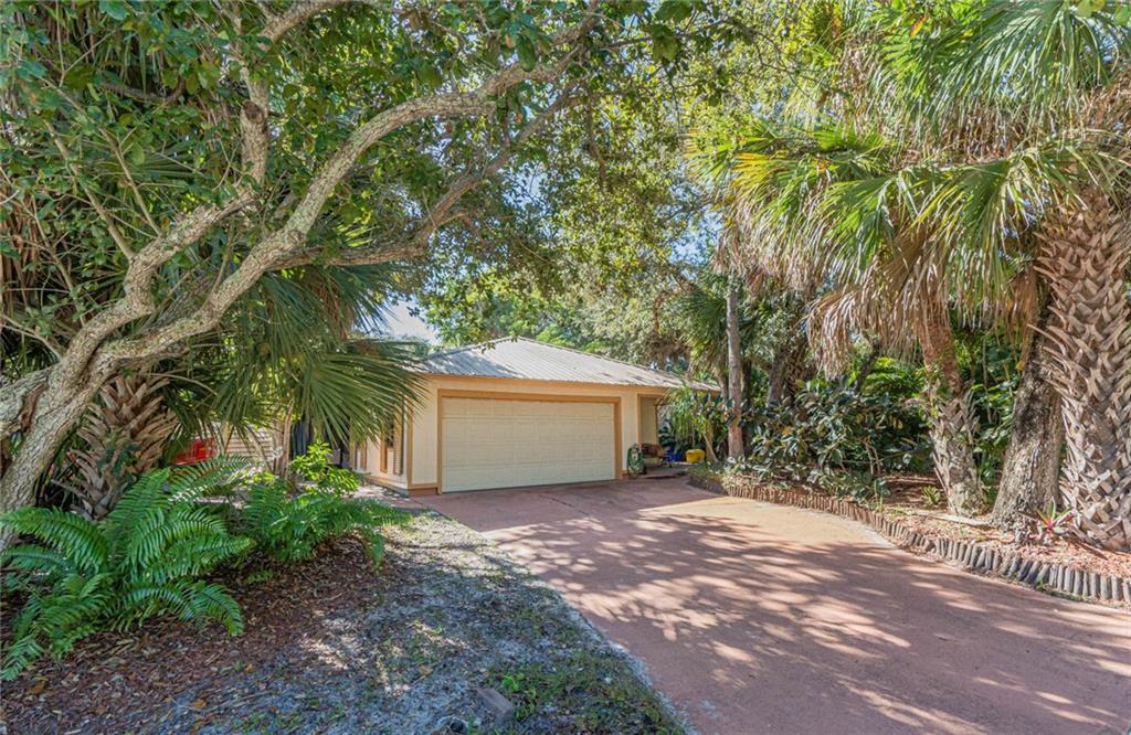 670 Cypress Road Vero Beach, FL 32963 - Photo 1 of 20 a view of backyard with large trees and plants