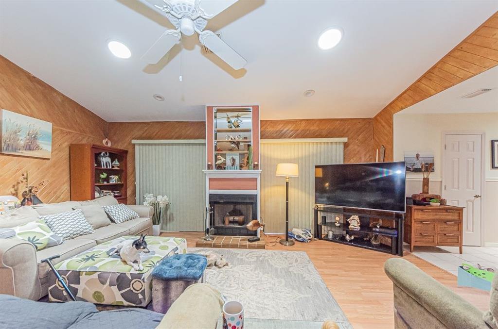 670 Cypress Road Vero Beach, FL 32963 - Photo 13 of 20 a living room with furniture a fireplace and a flat screen tv