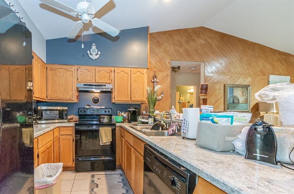 670 Cypress Road Vero Beach, FL 32963 - Photo 14 of 20 a kitchen with stainless steel appliances granite countertop a sink a stove and a wooden floors