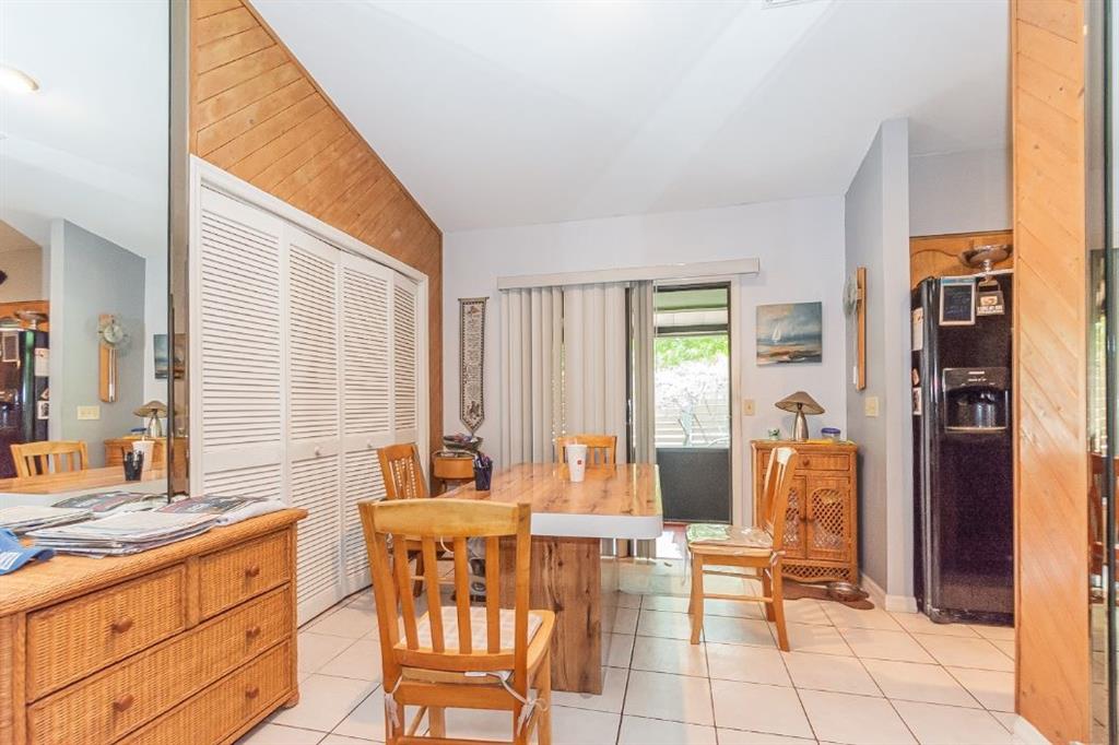 670 Cypress Road Vero Beach, FL 32963 - Photo 15 of 20 a dining room with furniture and large windows