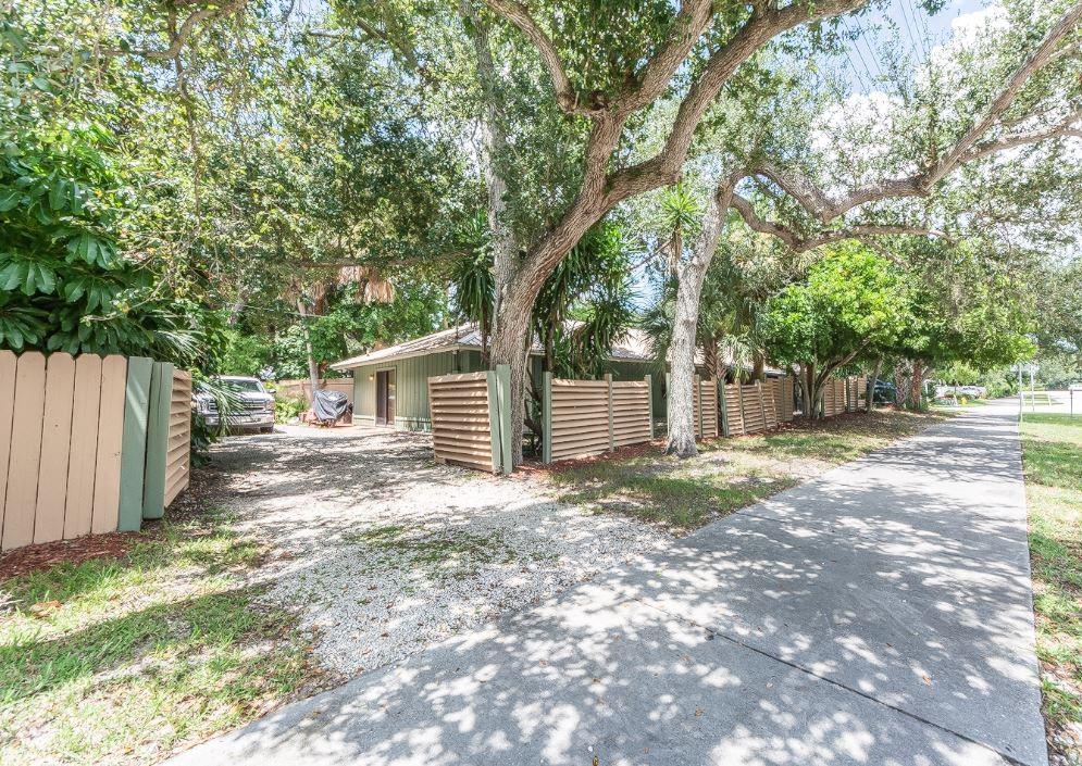 670 Cypress Road Vero Beach, FL 32963 - Photo 3 of 20 a view of a yard with large tree and wooden fence
