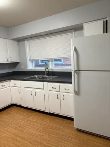 a stove top oven sitting inside of a kitchen