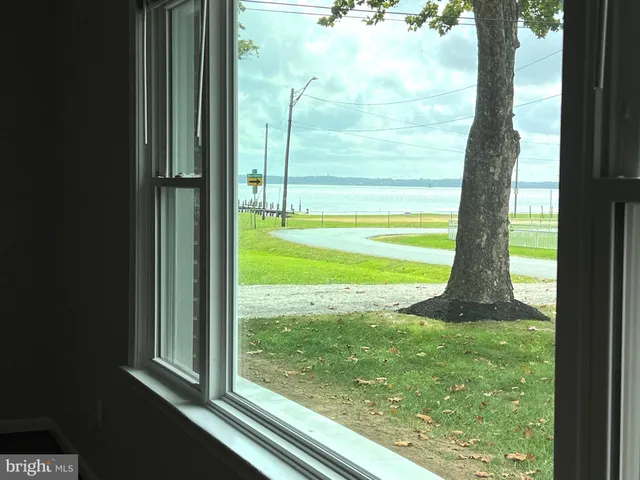 a kitchen with granite countertop a refrigerator and a stove top oven