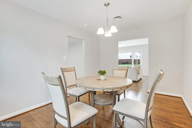 a view of a chairs and table in patio with a garden