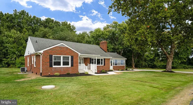 a living room with furniture large window and a fireplace