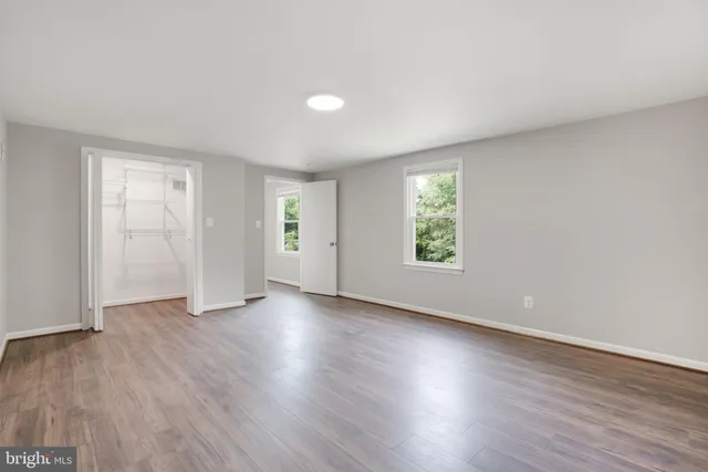 an aerial view of a house with a garden and lake view