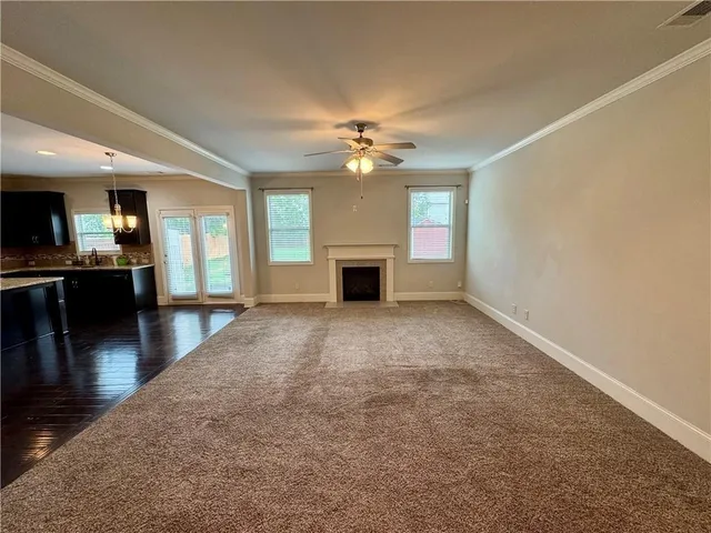 wooden floor in an empty room with a fireplace