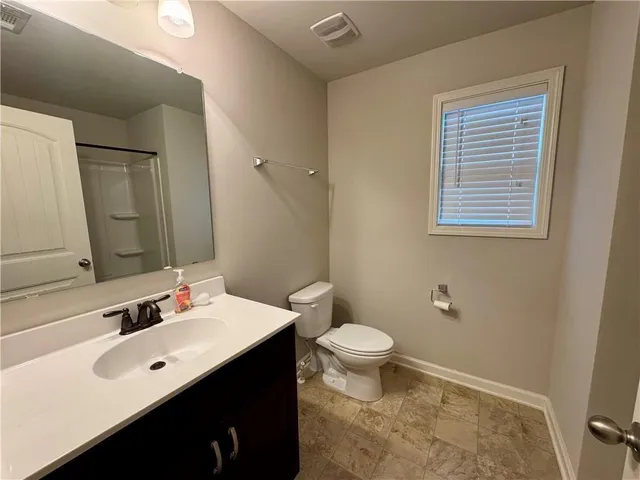 a bathroom with a sink toilet a mirror and vanity