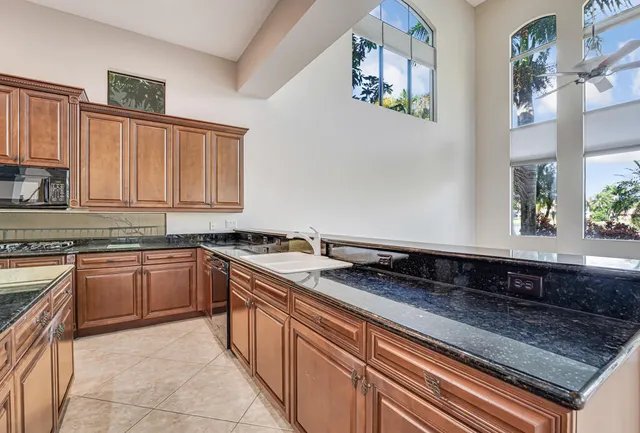 a view of a livingroom with a ceiling fan and window