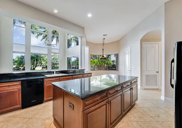 a spacious bathroom with a shower a sink and a mirror