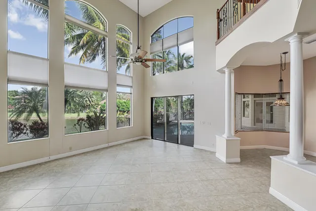 an empty room with closet and a chandelier fan