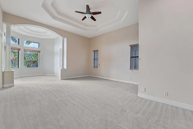 a front view of a house with a garden and trees