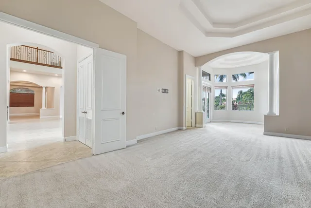 a front view of a house with a garden and a tree