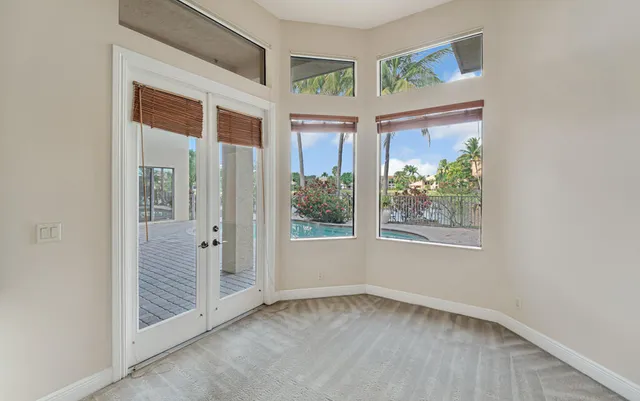 a front view of a house with a yard and potted plants