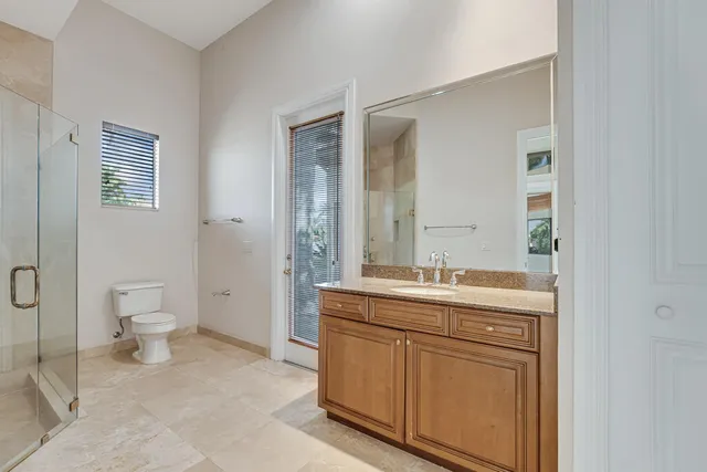 an aerial view of a house with a yard and lake view