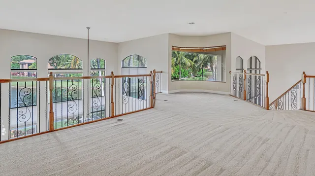 a front view of a house with swimming pool and porch with furniture
