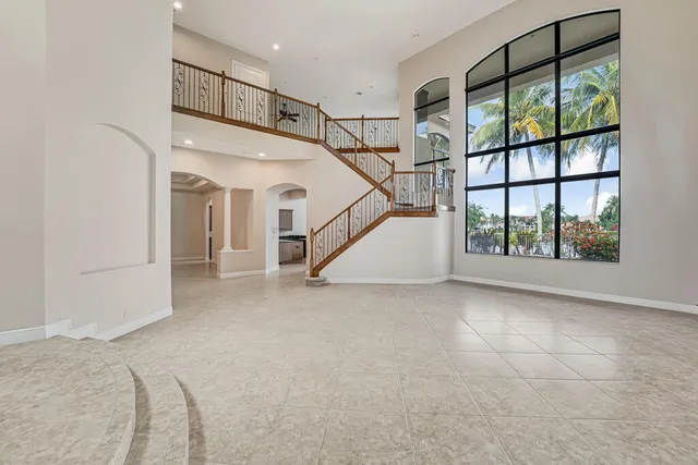 a kitchen with granite countertop white cabinets and a stove top oven