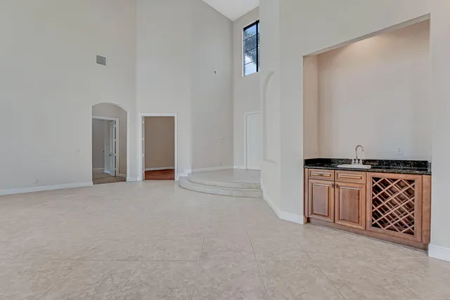 a kitchen with stainless steel appliances granite countertop a sink a counter and a large window