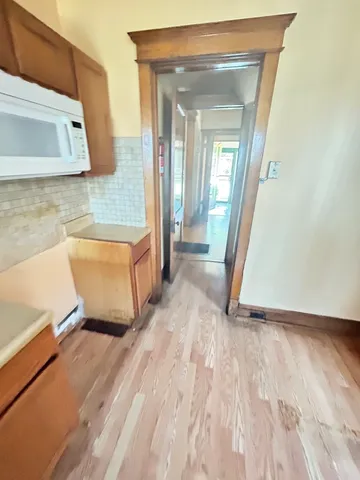 a view of a room with wooden floor and a sink