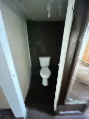 a view of staircase with lots of frames on wall and a large window