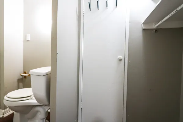 a white toilet sitting next to a white sink