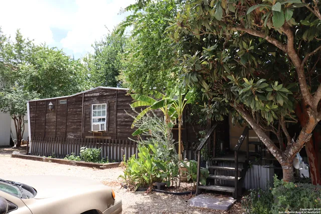 a brick house with a tree in front of it