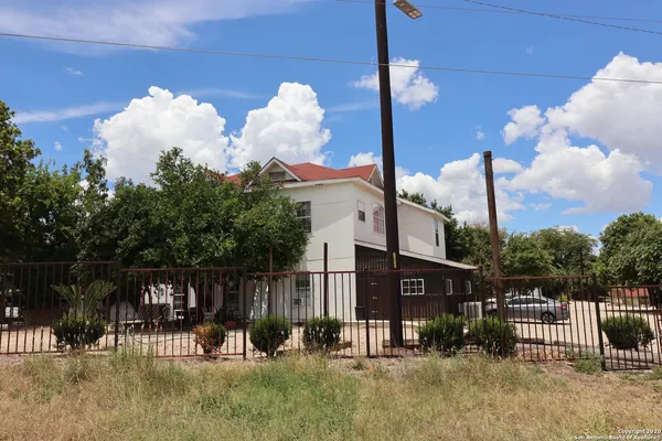 a view of a house with a fence