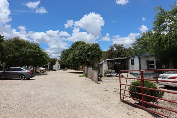 a view of a backyard with a car parked in it