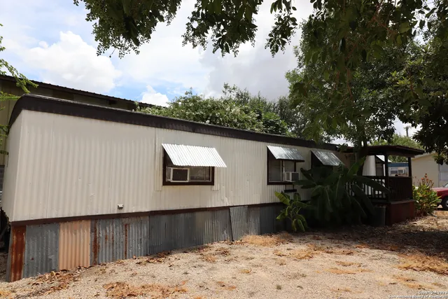 a view of a house with a wooden fence