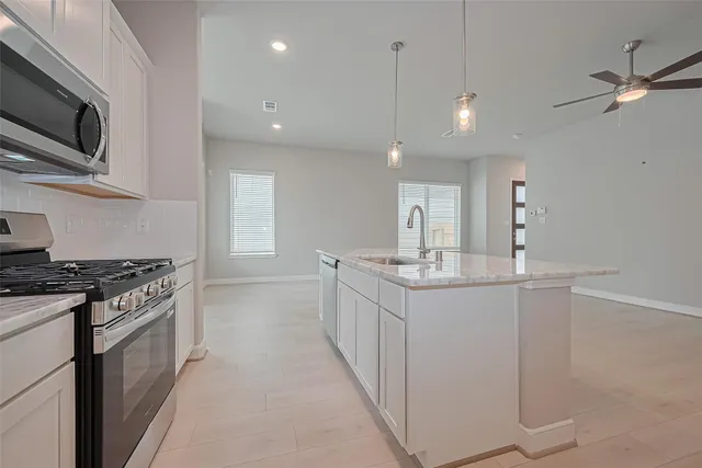 a kitchen with stainless steel appliances a sink dishwasher stove and microwave