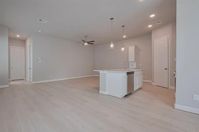 a view of a kitchen with a sink and cabinets