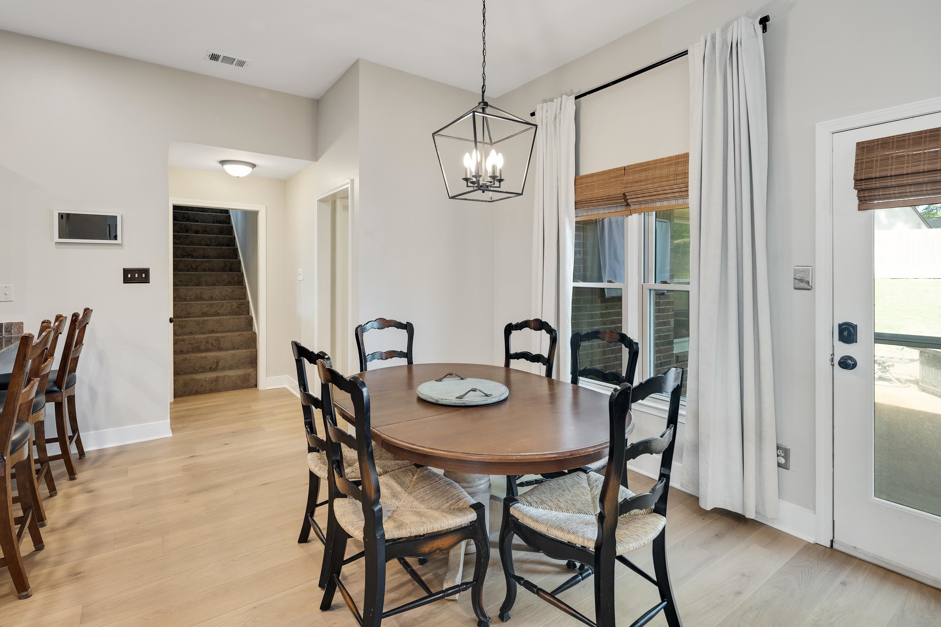 288 Hughes Cove Collierville, TN 38017 - Photo 11 of 31 Dining space with light wood-style flooring, hanging lights, and plenty of natural light