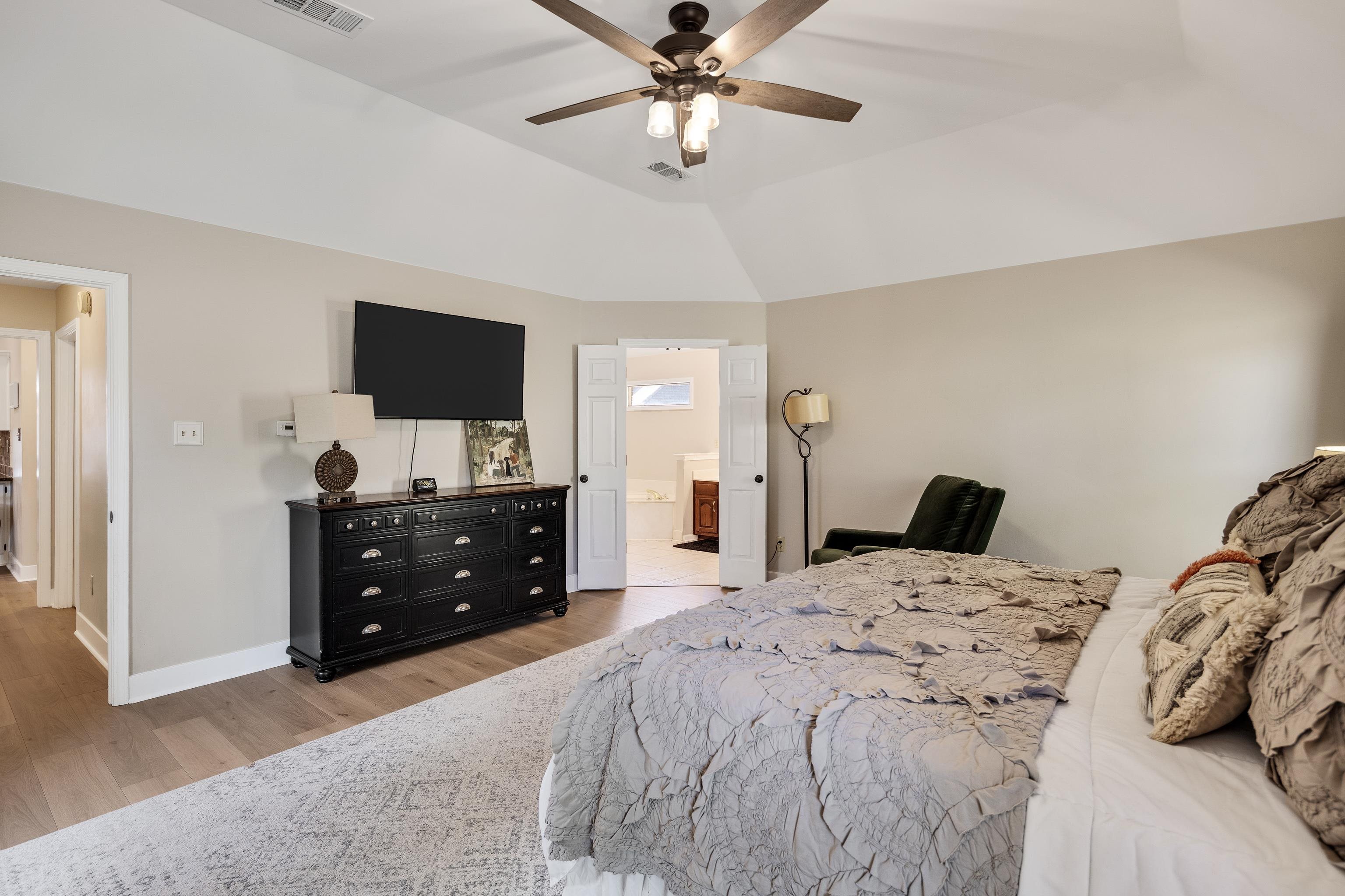 288 Hughes Cove Collierville, TN 38017 - Photo 17 of 31 Bedroom featuring light wood finished floors, ceiling fan, vaulted ceiling, and connected bathroom