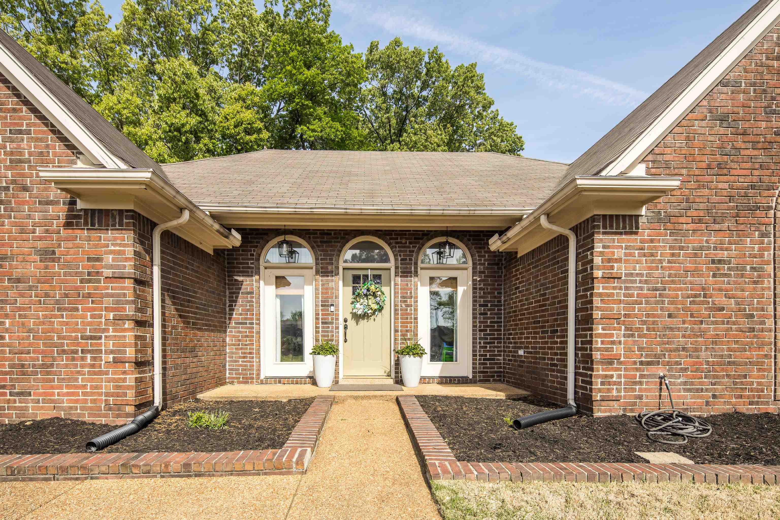 288 Hughes Cove Collierville, TN 38017 - Photo 2 of 31 View of exterior entry featuring brick siding and roof with shingles